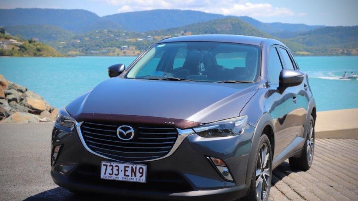 Heart of Reef Car for rent in front of Airlie Beach Background