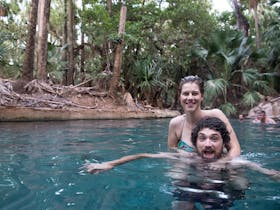 two people swimming in thermal springs