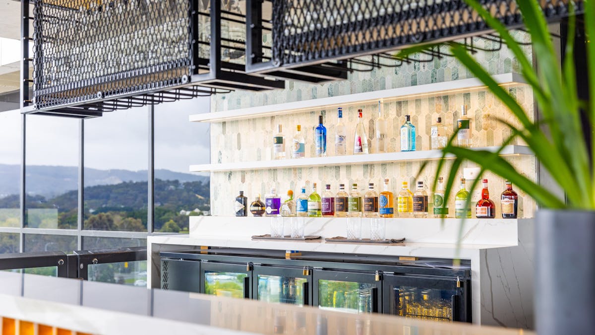 Bar with drinks and glasses with a hinterland view