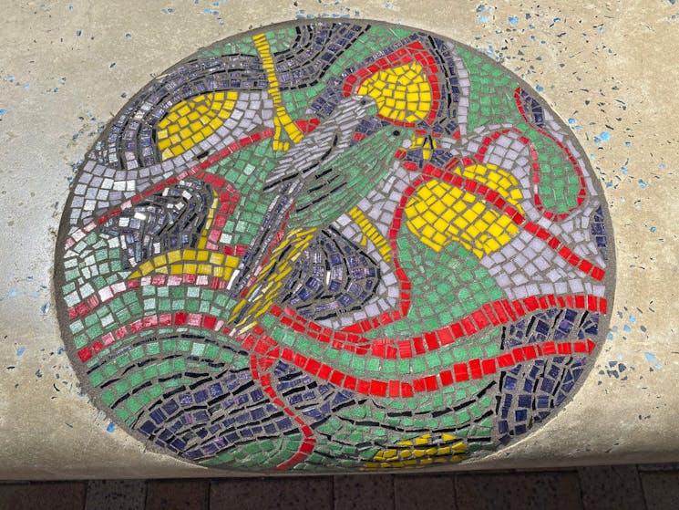 Circular mosaic depicting birds