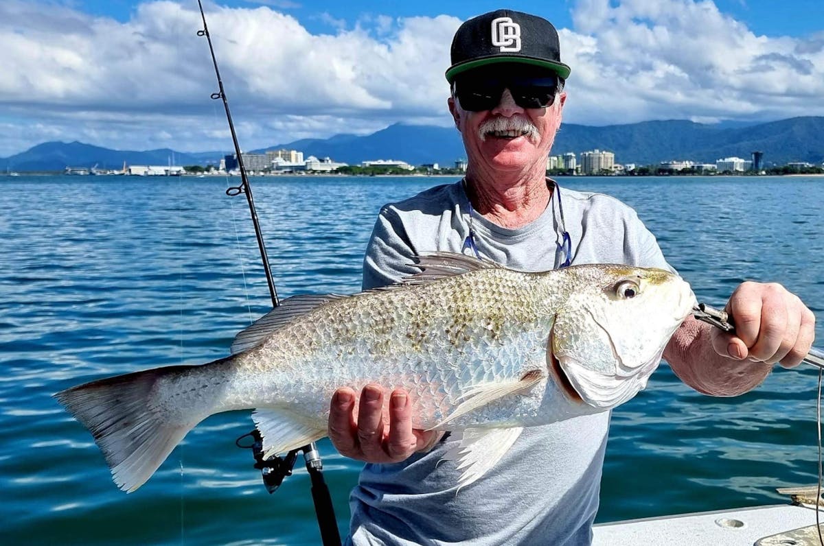 Man holding a big grunter fish with Gone Fishing Cairns on Trinity Inlet