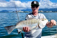 Man holding a big grunter fish with Gone Fishing Cairns on Trinity Inlet