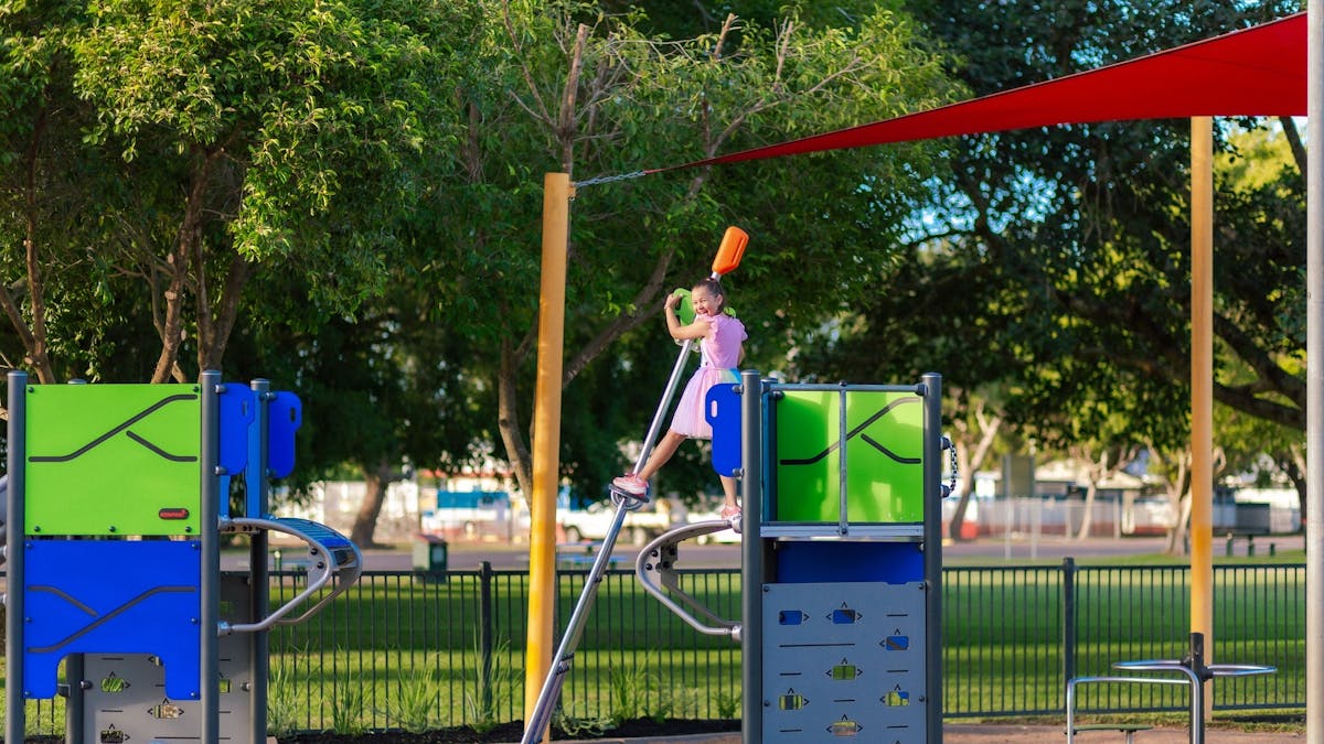 A girl playing on the playground equipment at Anzac Park