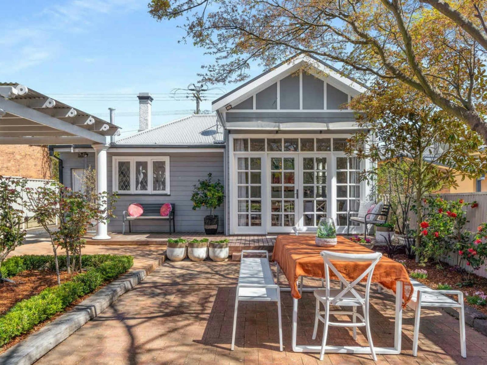 Dining Table and chairs in the back outdoor area of Clinton Charm - Stunning Heritage Home near CBD
