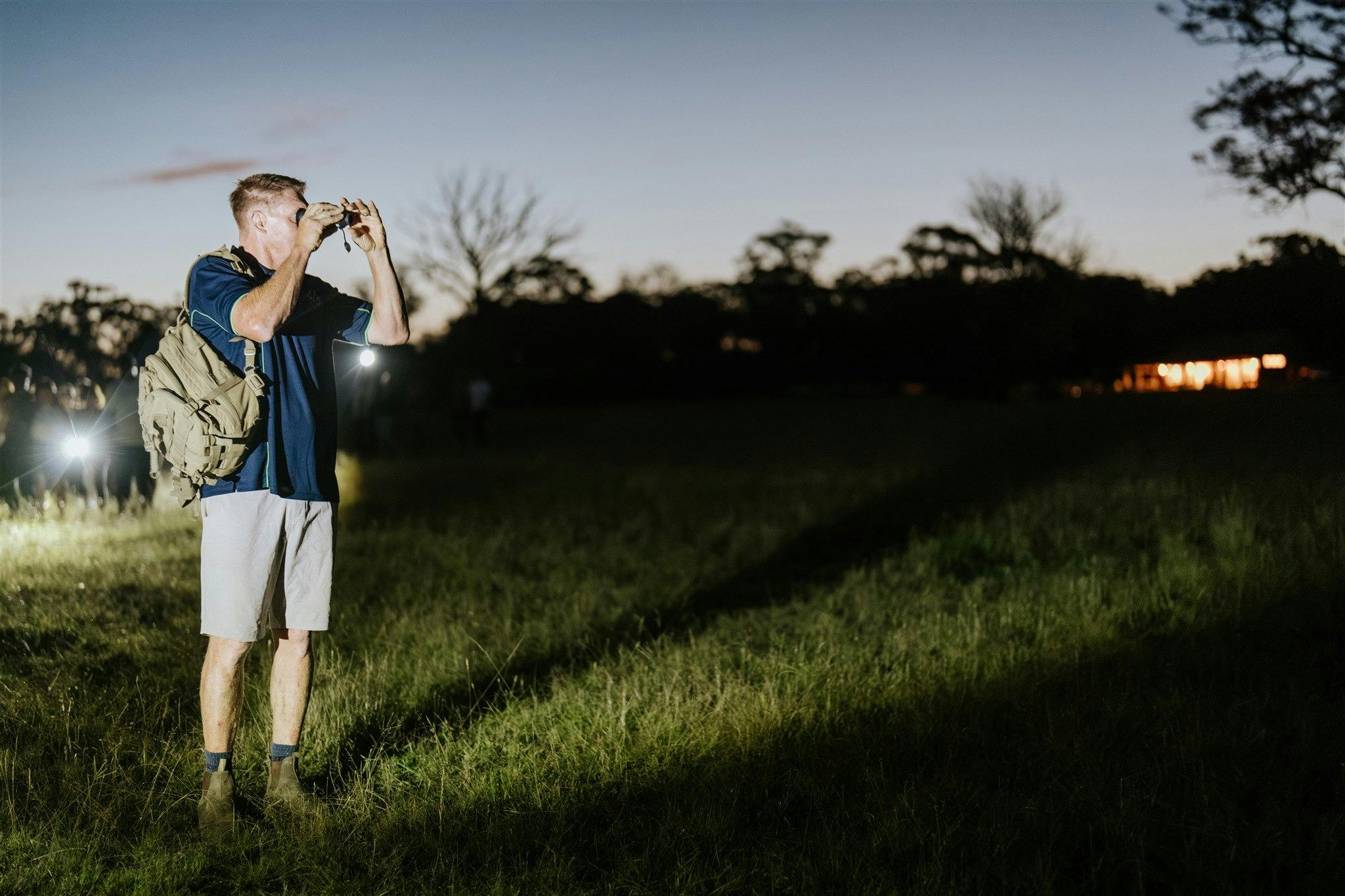Our guide using the thermal night vision monocular to spot native animals at night  in our paddocks