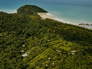 Aerial photo of Cape Trib Farm with Cape Tribulation in background