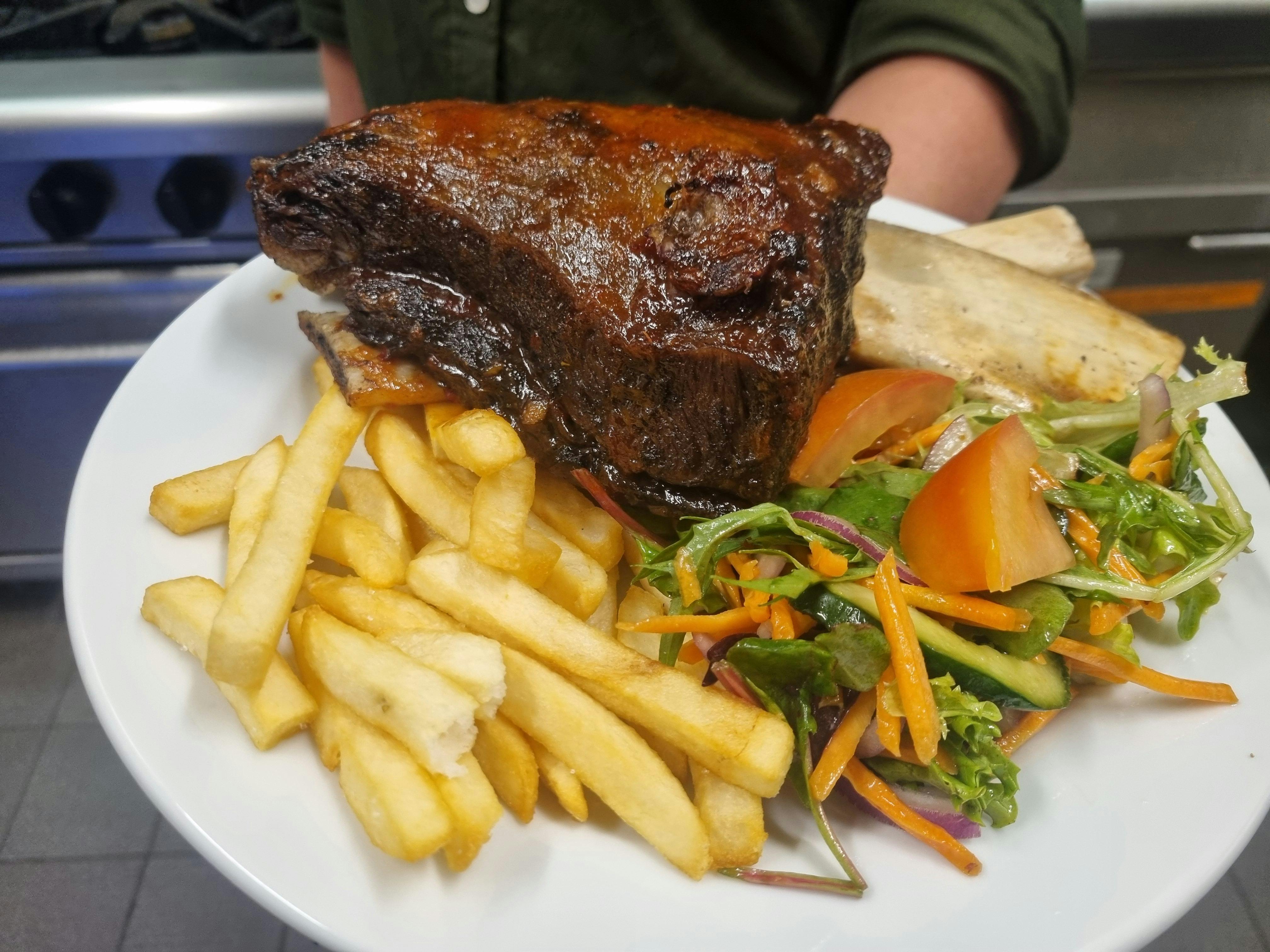 Slow Cooked Beef Rib with chips and salad