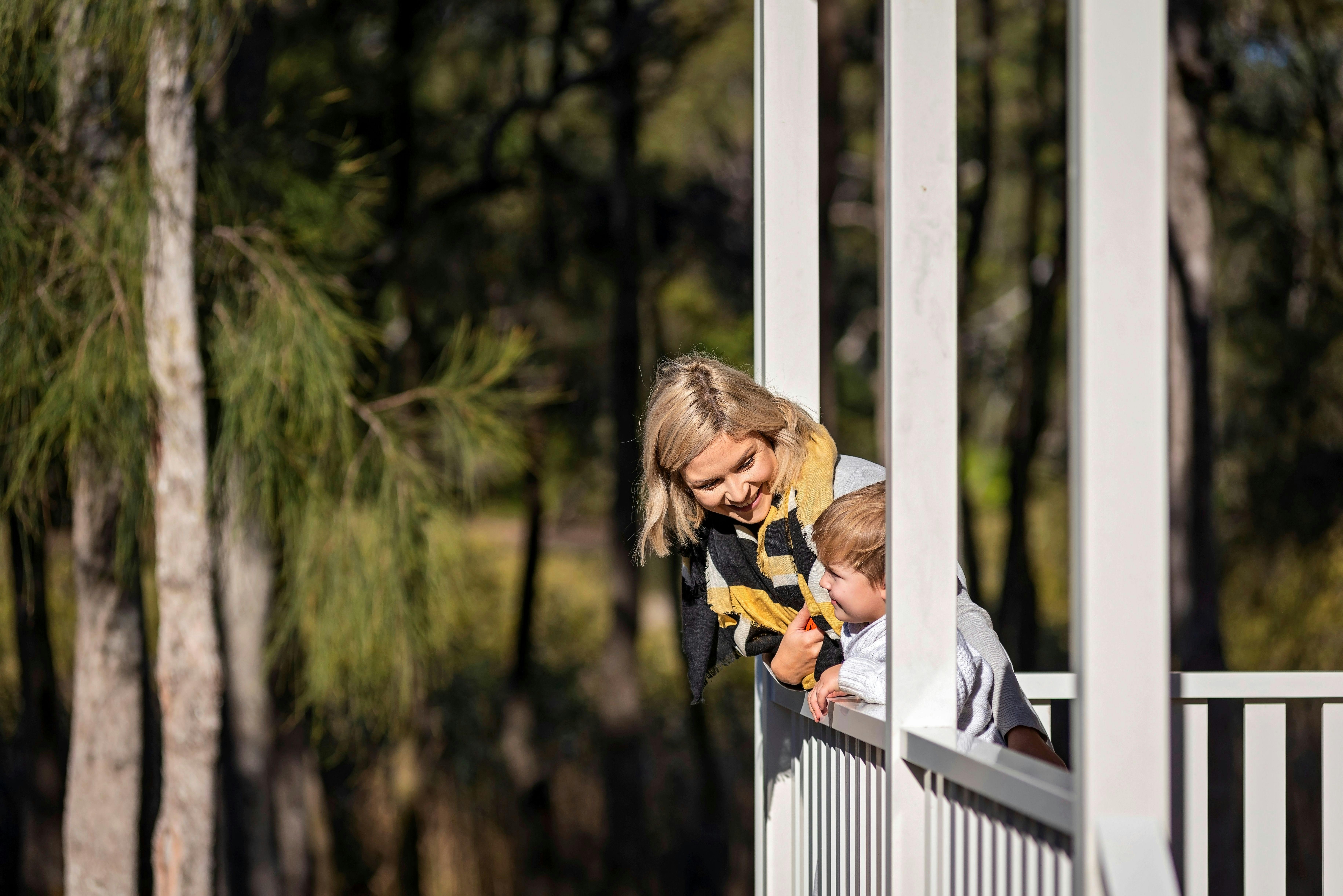 Family on Balcony of cabin at Discovery Parks - Gerroa