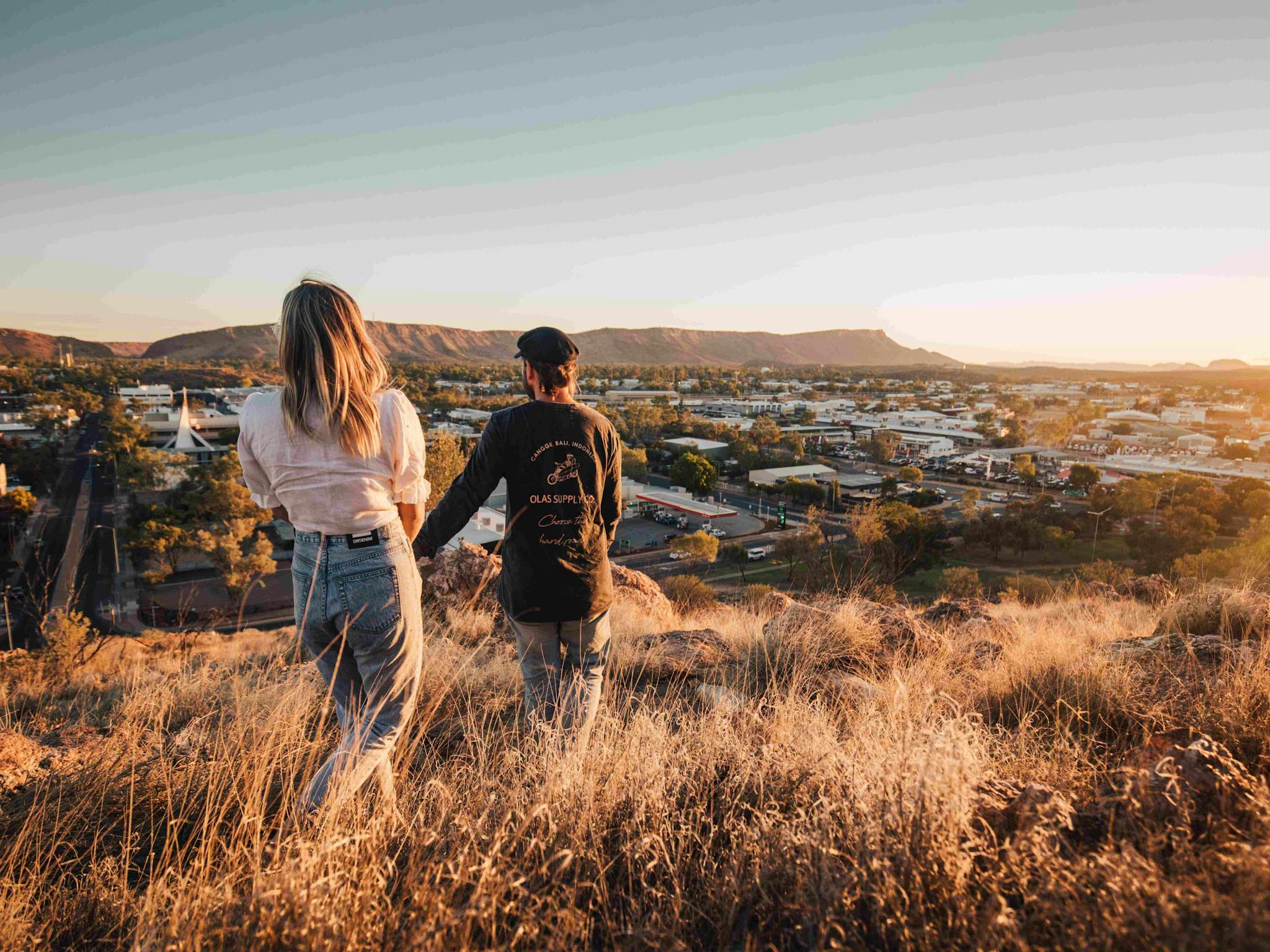 Couple walking down Anzac hill in Alice Springs