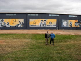 Artist Sam Brooks and his assistant Mark Harding with the completed mural.