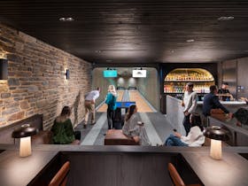 Guests play in the bowling alley on-site