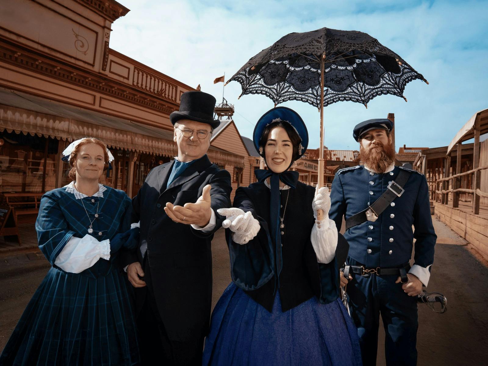 Four costumed performers - 2 men, 2 women, standing on Sovereign Hill's Main Street