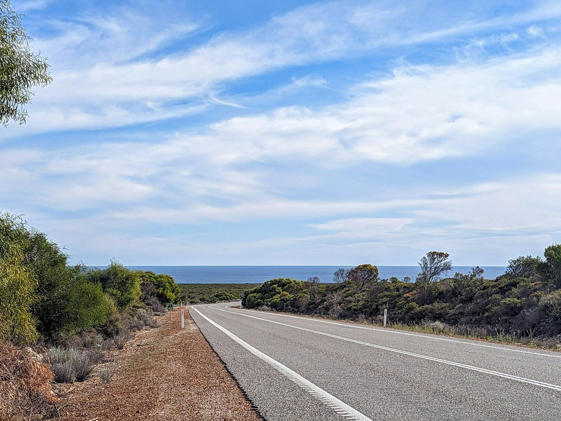 Open road curving torwards the Ocean