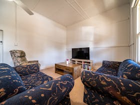 Lounge room features a 60 Smart TV and plenty of comfortable seating