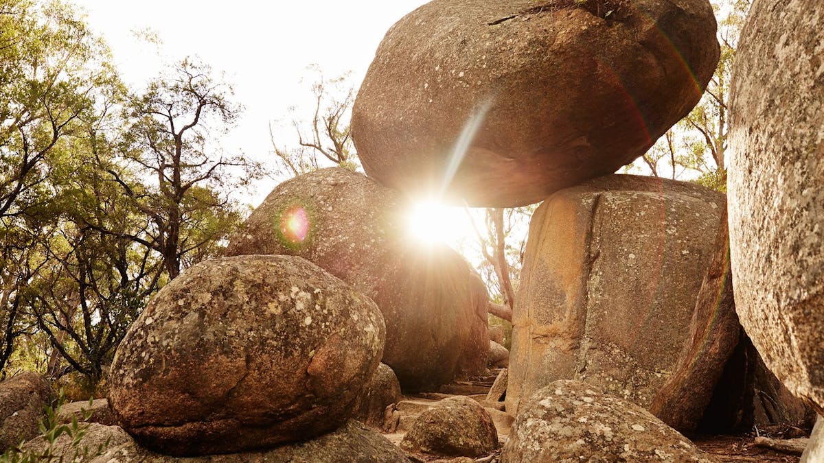 An impressive granite rock formation gives the impression of a balancing rock.
