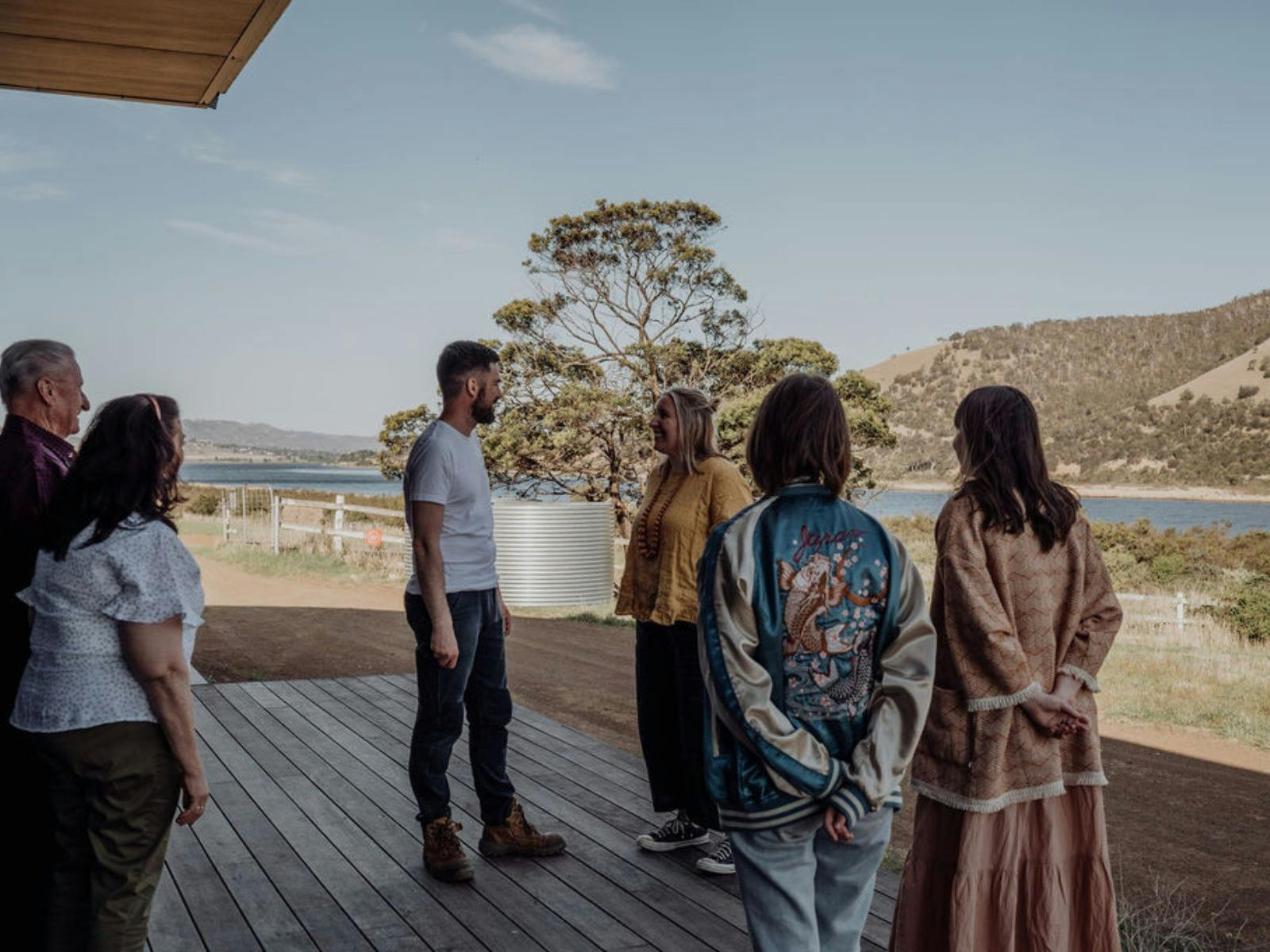 People  standing on the distillery deck enjoying the view of the Derwent River