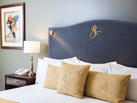 King bed with velvet headboard, Deluxe Spa Suite, Royal on the Park Hotel Brisbane