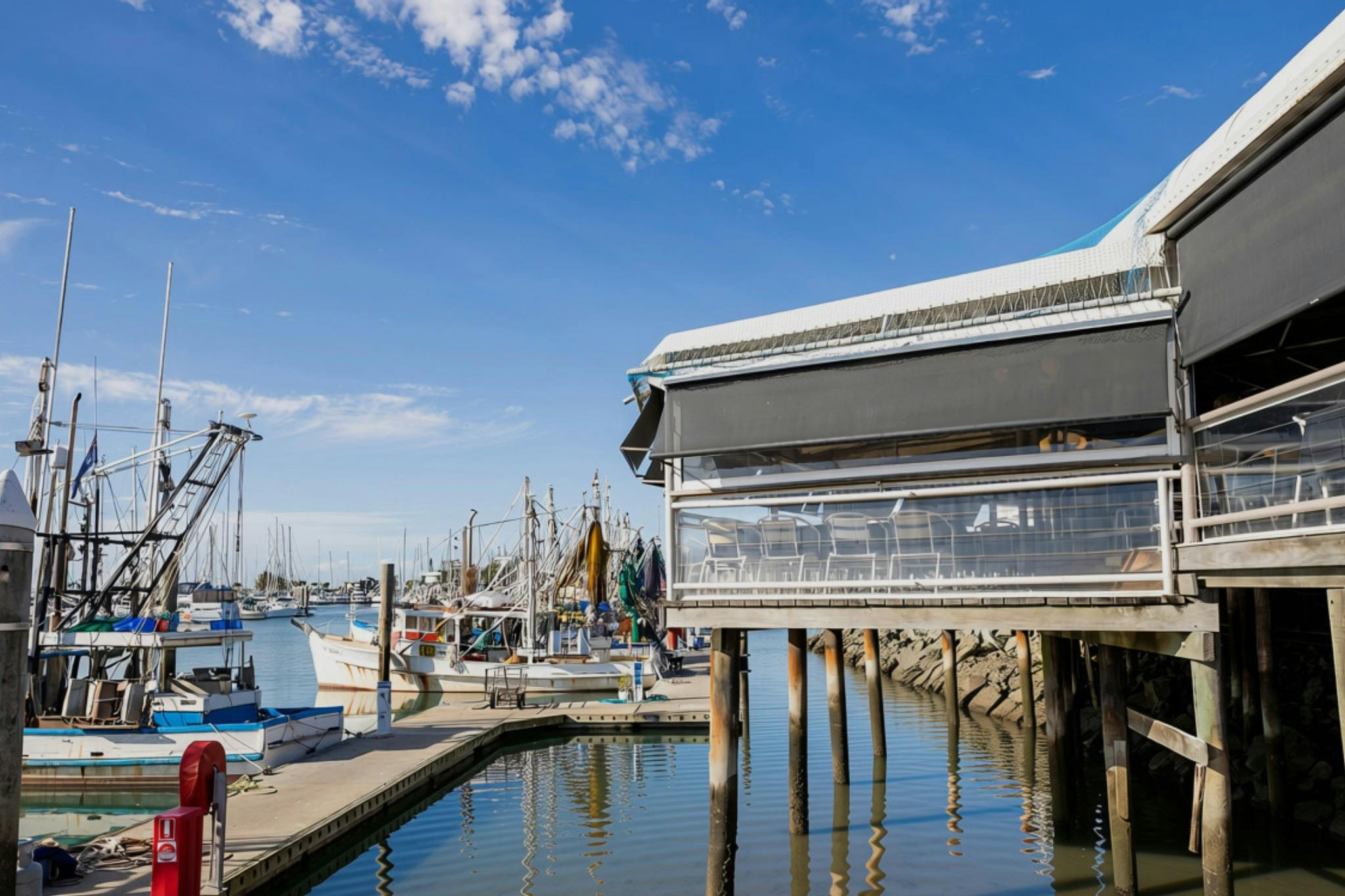 Exterior of Tempest Restaurant overlooking fishing boats and the marina