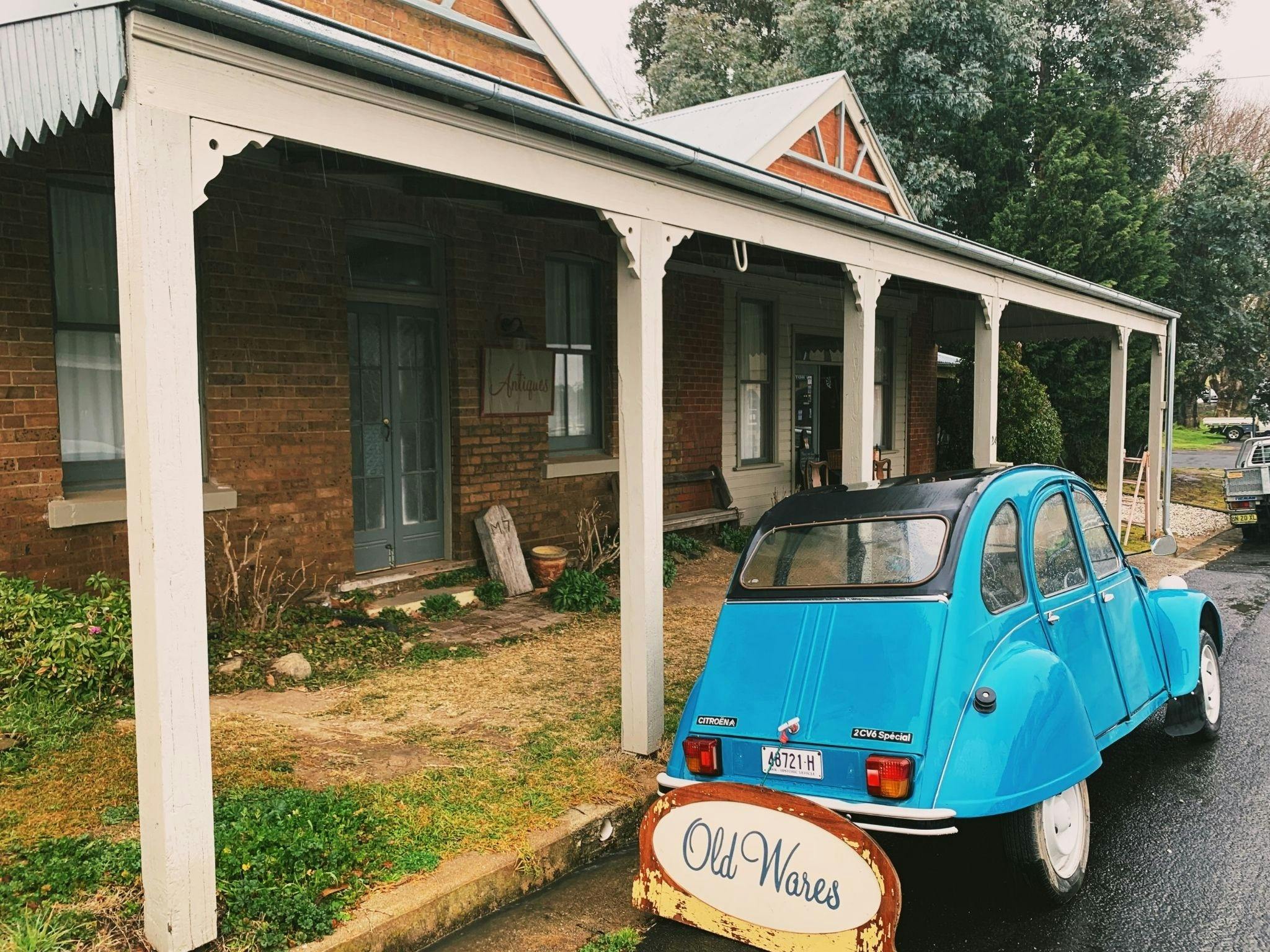 old car in front of antique shop