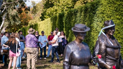She Shapes History tour guide presenting to the group of engaged guests