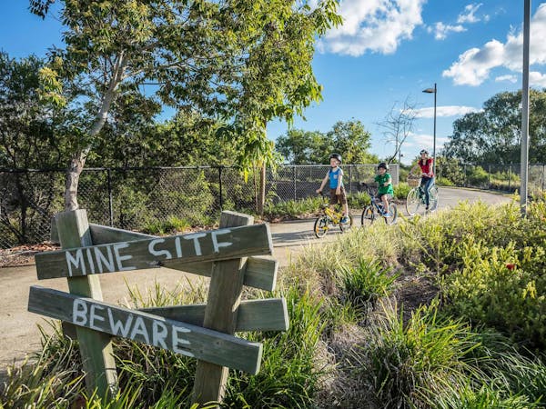 Family riding bikes on Brassall Bikeway