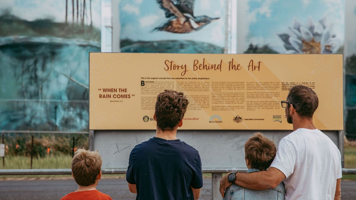Young family reading the sign at the Yelarbon Silos