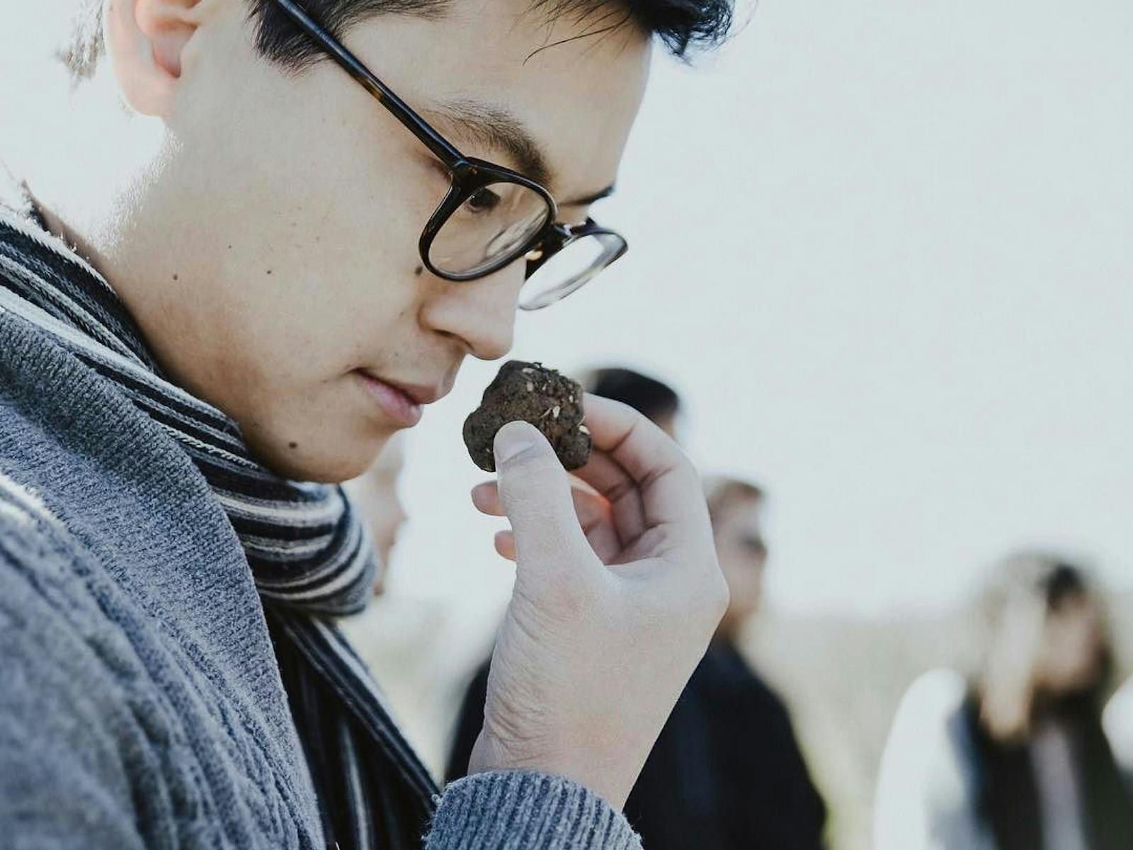 Asian man smelling a truffle