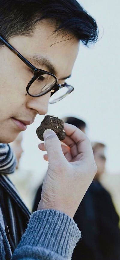 Asian man smelling a truffle