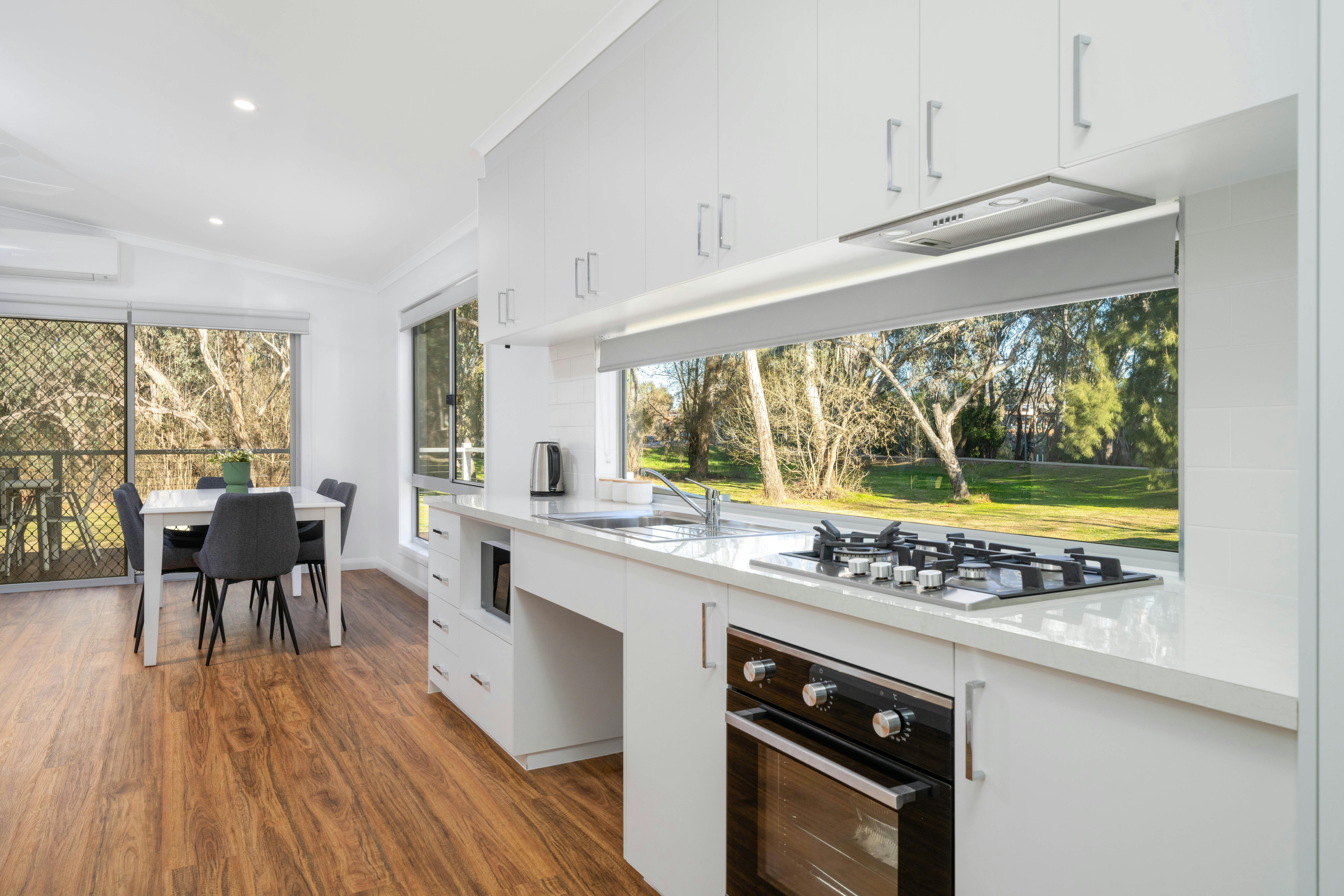 Premium family cabin showing dining and living area, as well as full kitchen