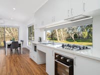 Premium family cabin showing dining and living area, as well as full kitchen