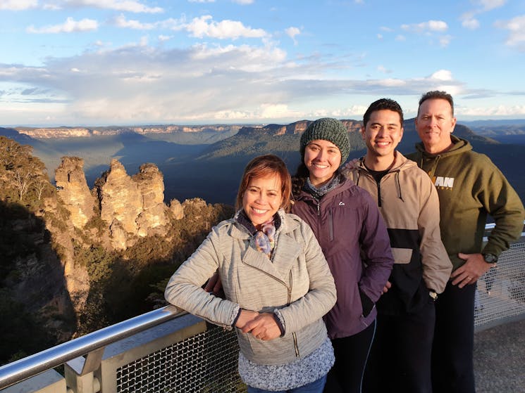 Family of four with Three Sister Blue Mountains in the background