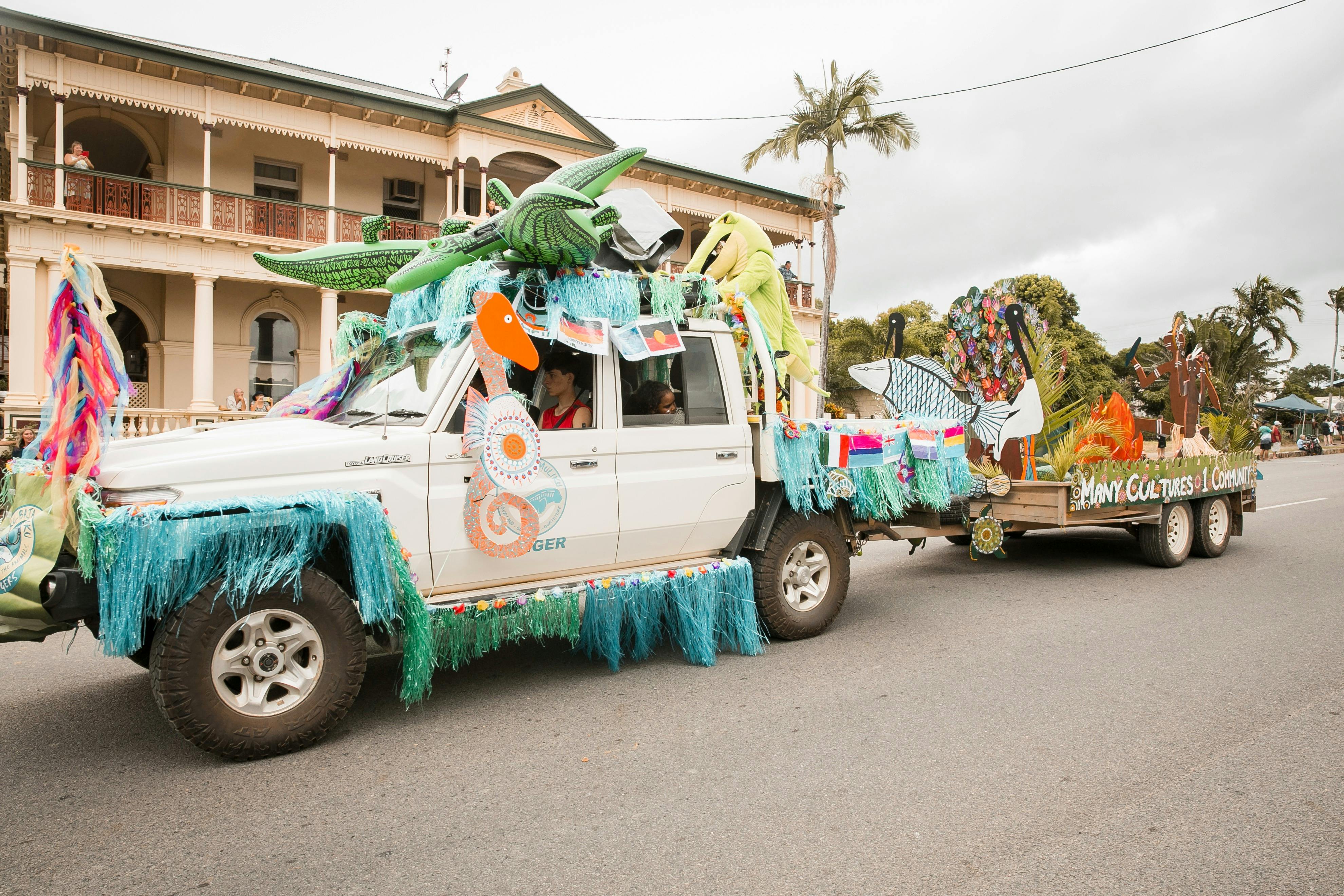 Decorated ute in the street parade in front of a heritage listed building
