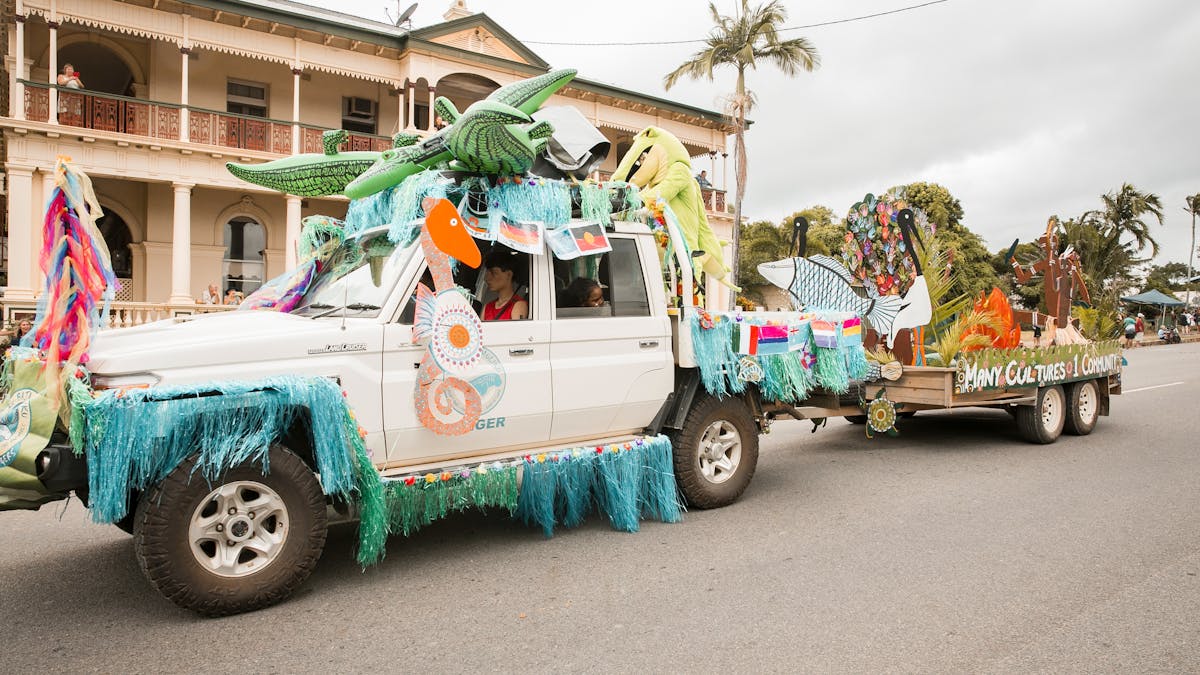 Decorated ute in the street parade in front of a heritage listed building Decorated ute in the street parade in front of a heritage listed building