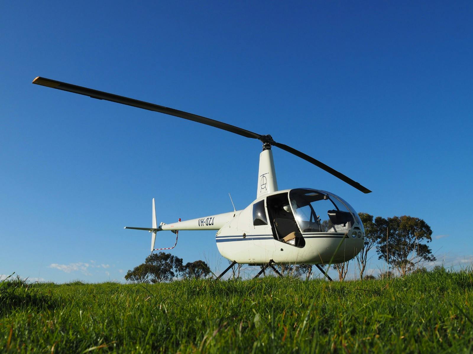 South Australian Helicopters helicopter in a green field