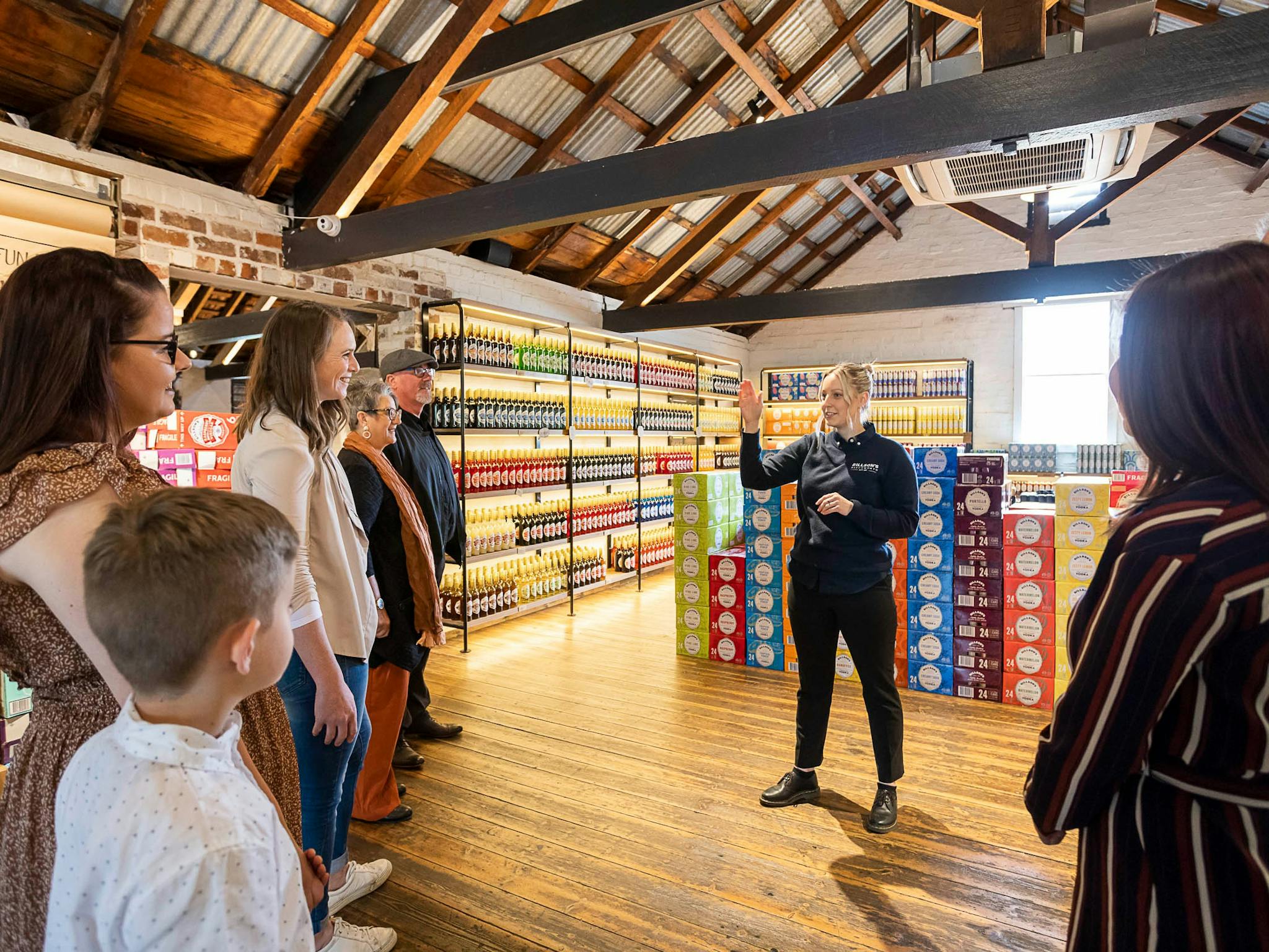 Tour hosts talking to guests in the Retail room