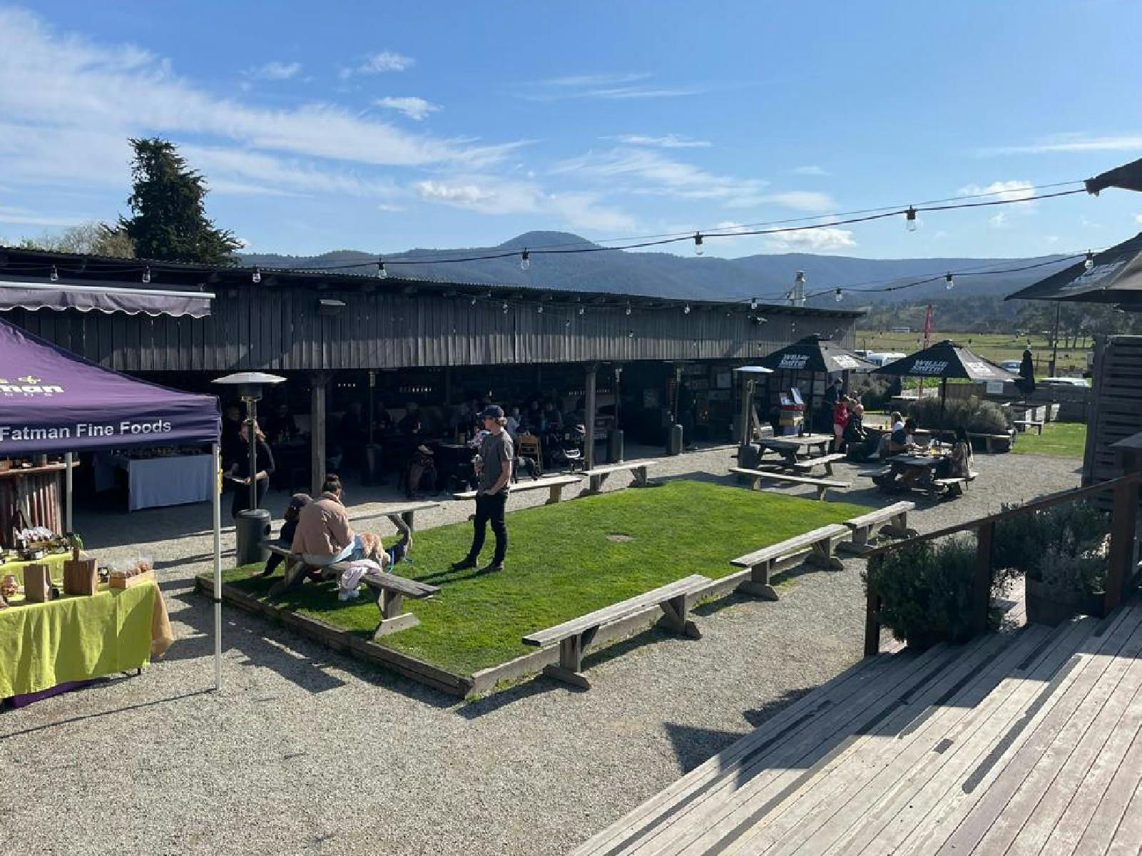 A wide shot showing the other side of the Apple Shed barn with stalls inside.