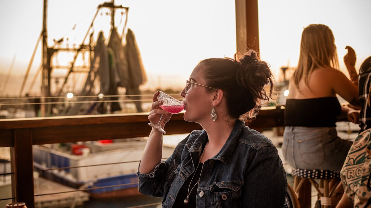 Woman drinking, overlooking the Marina