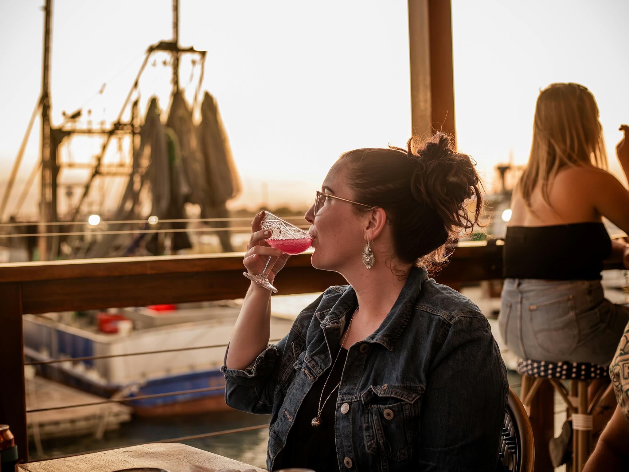 Woman drinking, overlooking the Marina Woman drinking, overlooking the Marina