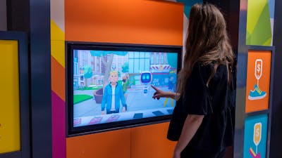 Woman playing touchscreen game in DemocraCity