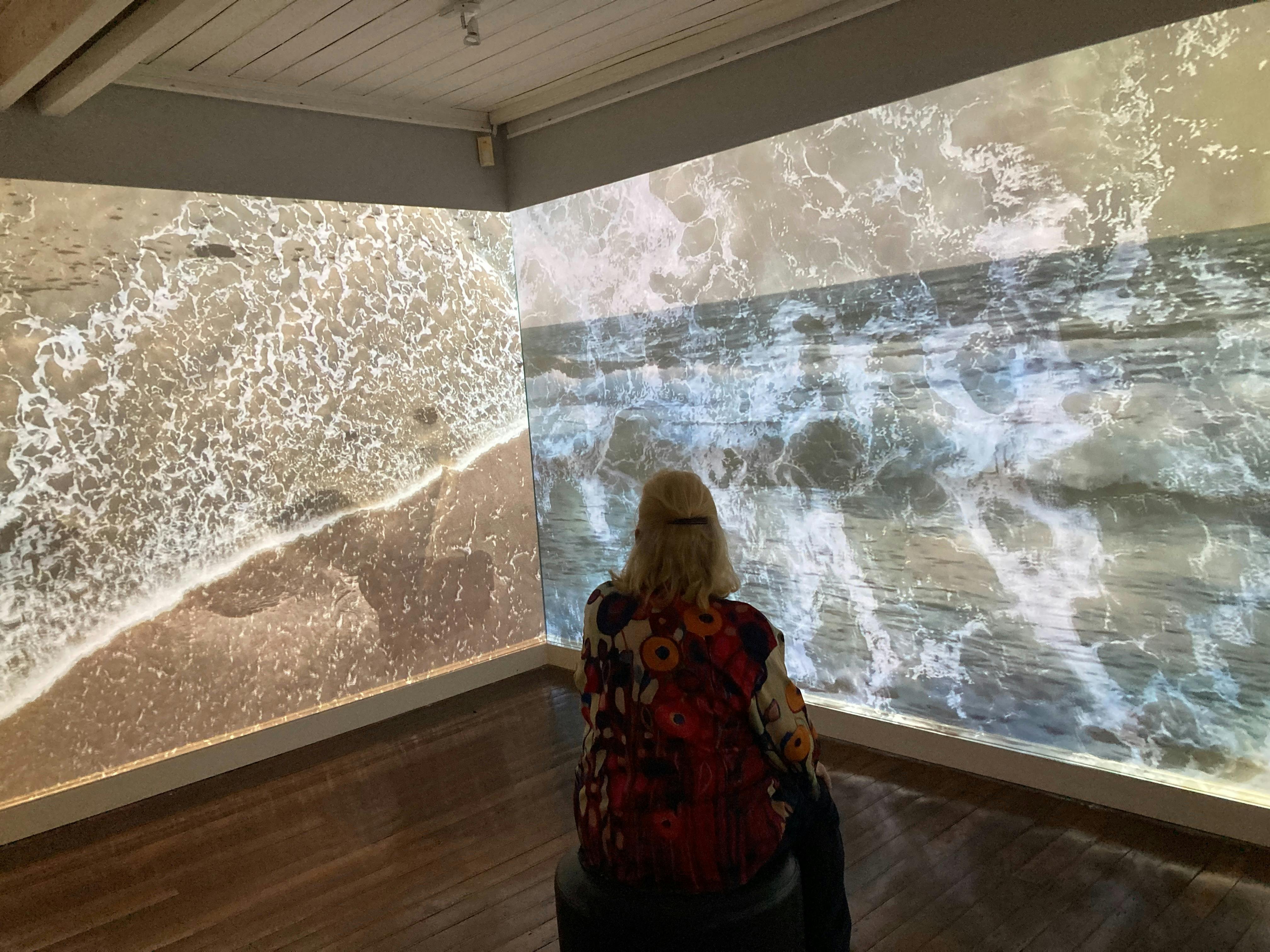 woman watching Birpai Country Stories installation