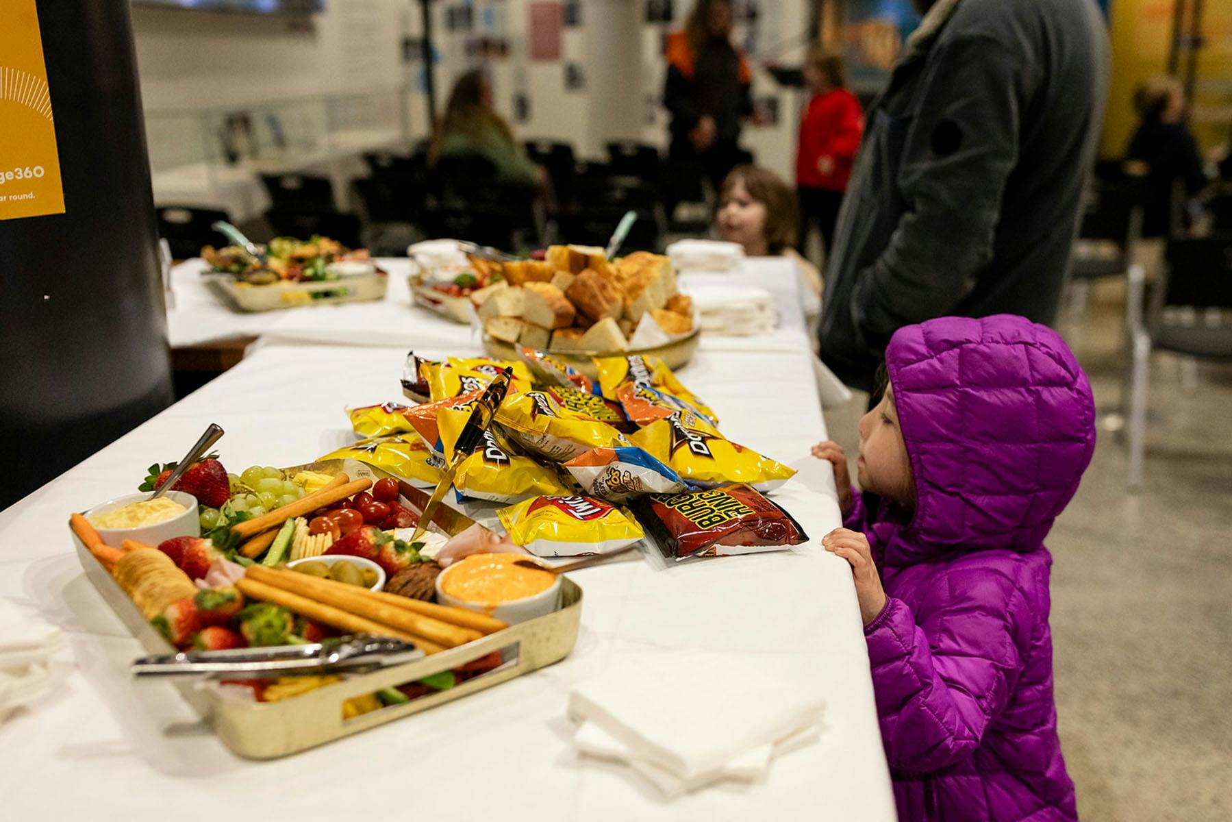 A young visitor checks out refreshments at an exhibition opening.