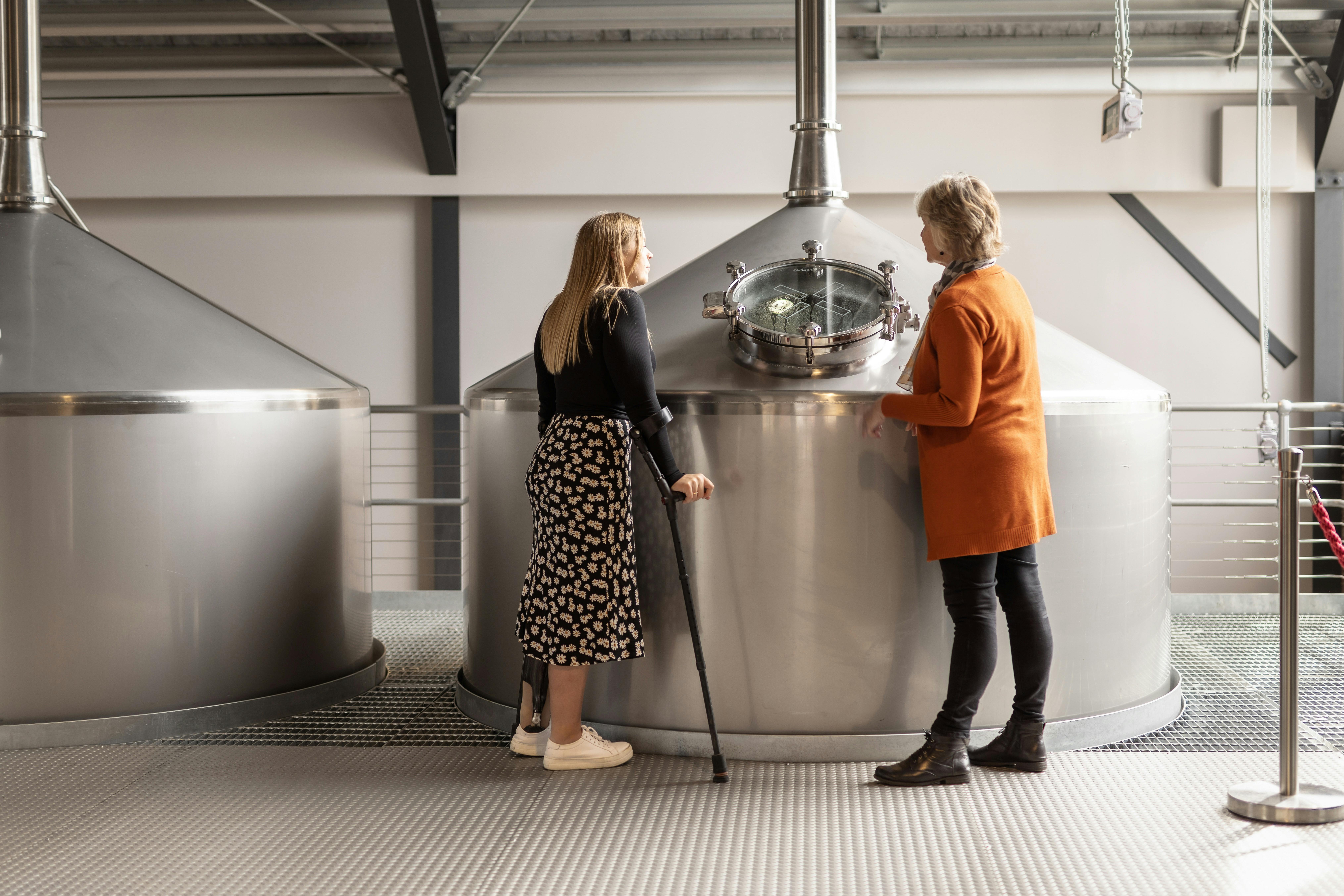 Two women looking into a whisky still