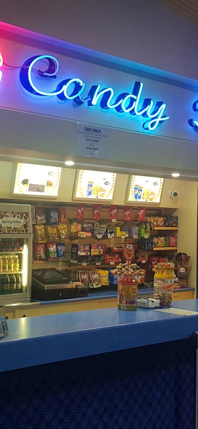 Candy bar all lit up with display of lollies and popcorn.