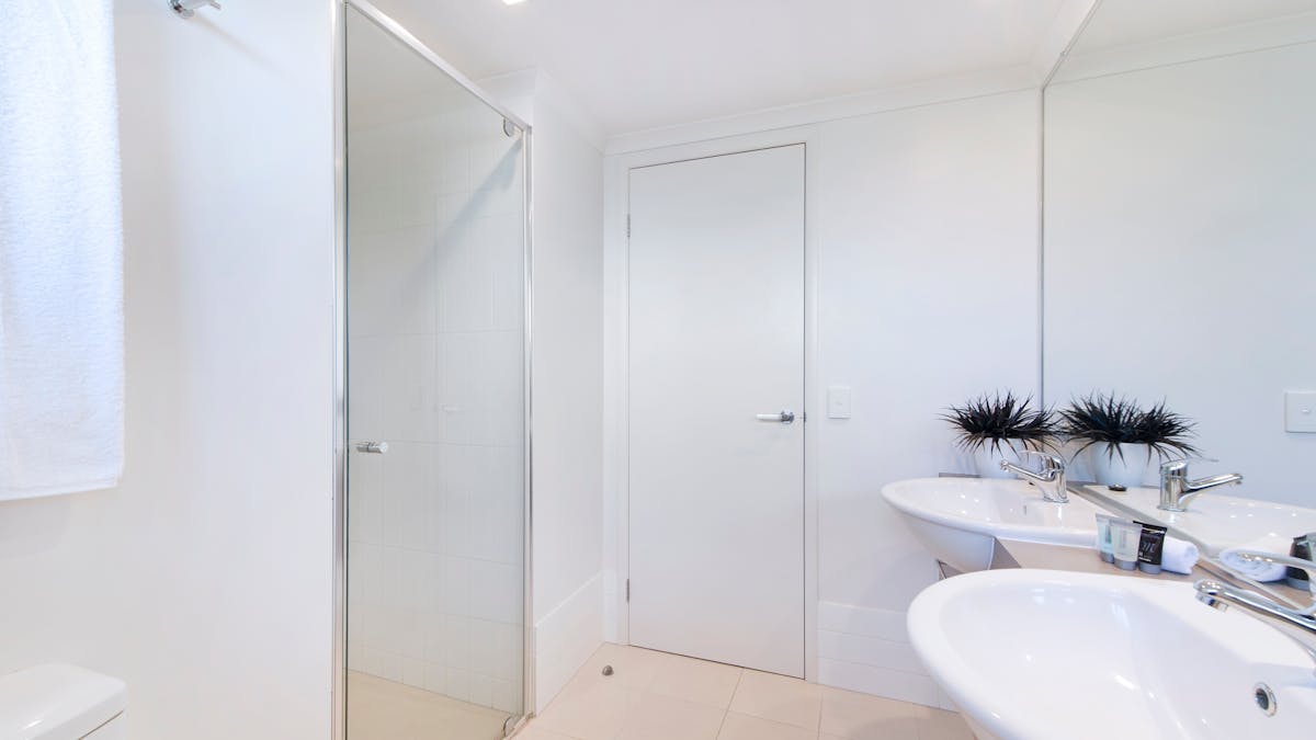 Bathroom - his & hers vanities. Walk-in showers.