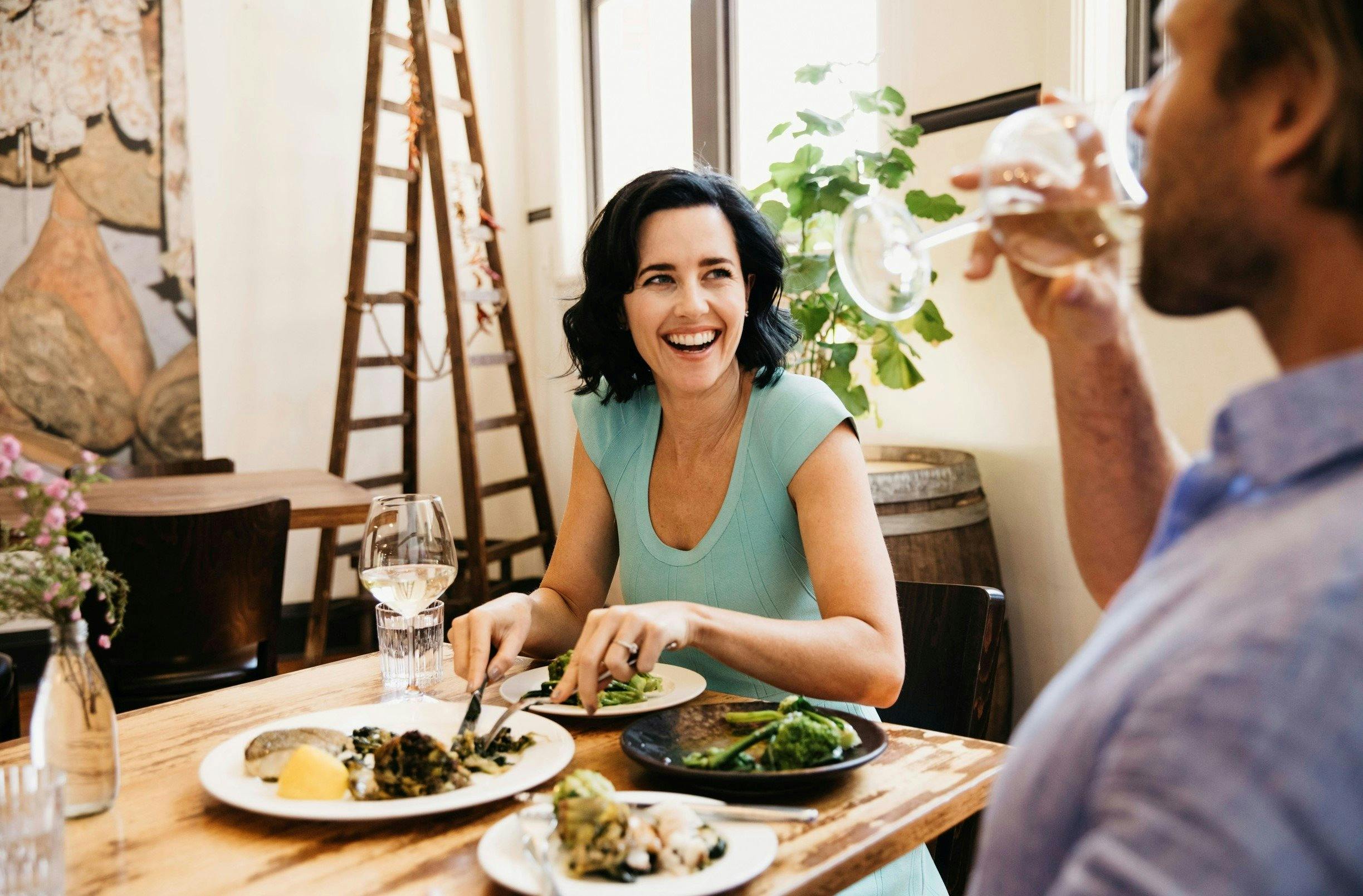 Couple enjoying food and drink at Zecca Restaurant, Griffith