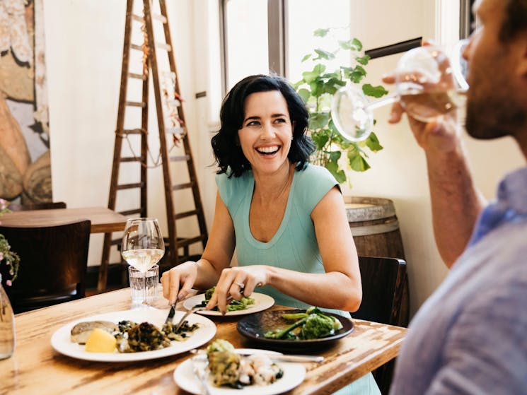 Couple enjoying food and drink at Zecca Restaurant, Griffith