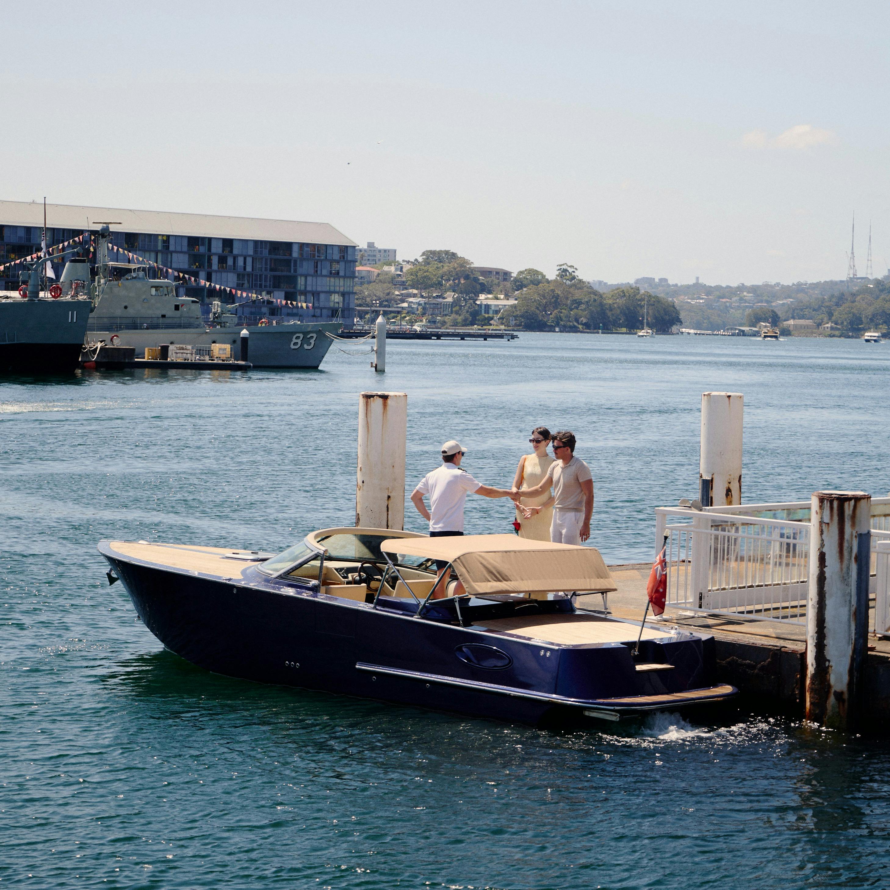 Private boat tour on MV Aquamajestic cruising Sydney Harbour with city skyline views.