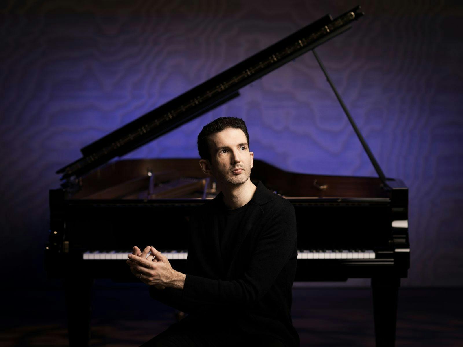 Internationally acclaimed pianist Emmanuel Despax sits by the piano