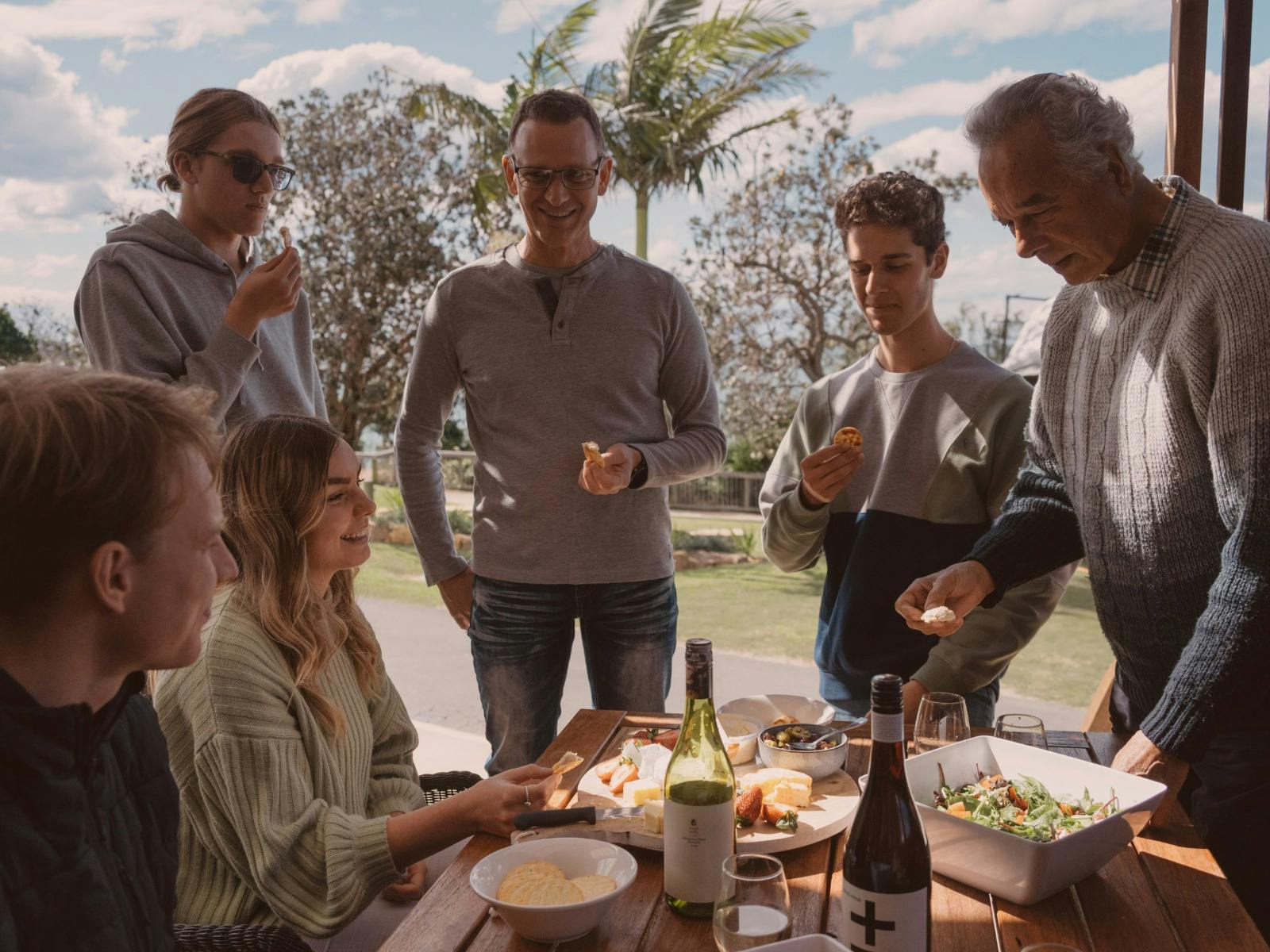 Family gathered around a table of food