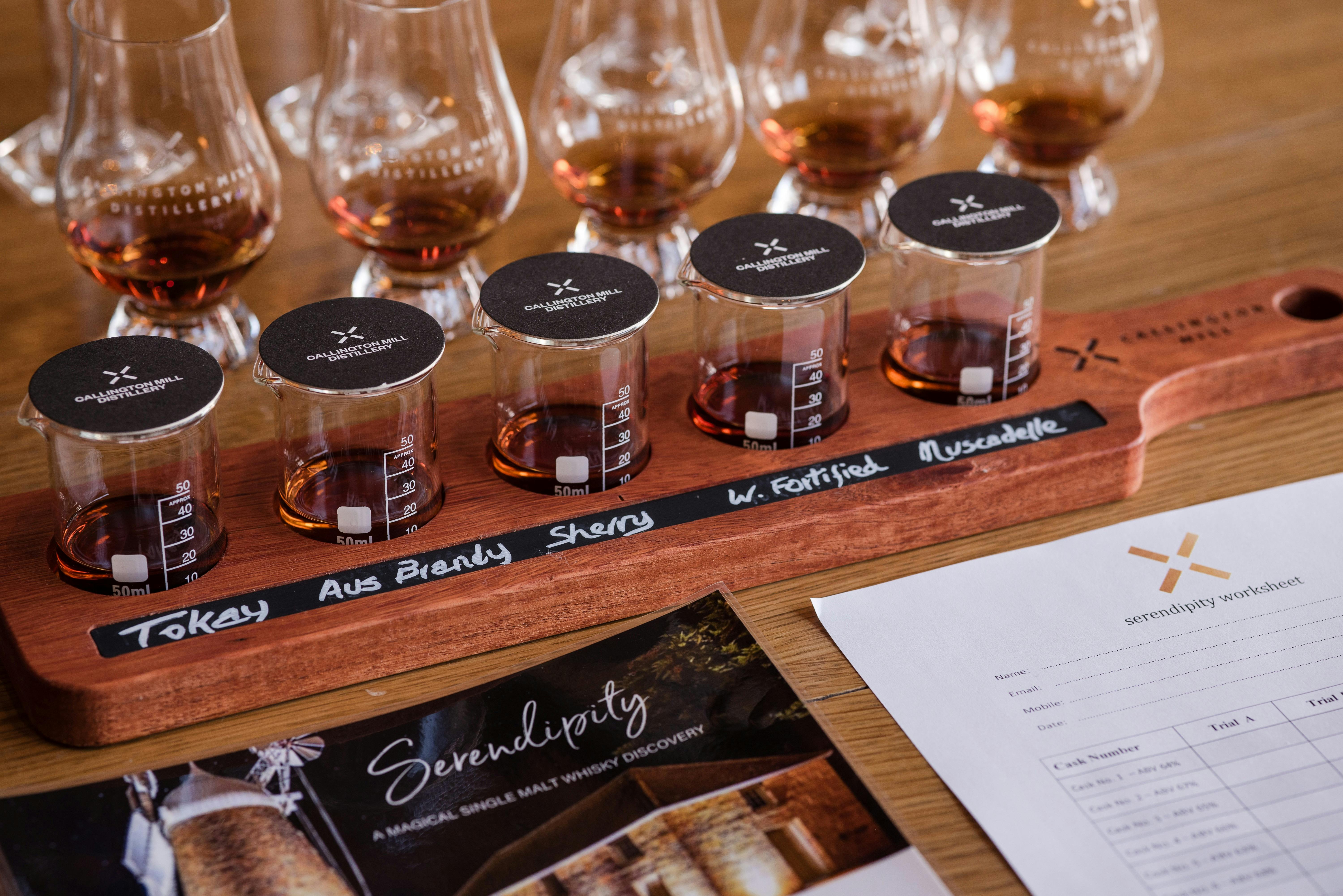 A paddle of whisky glasses with a worksheet and tasting notes